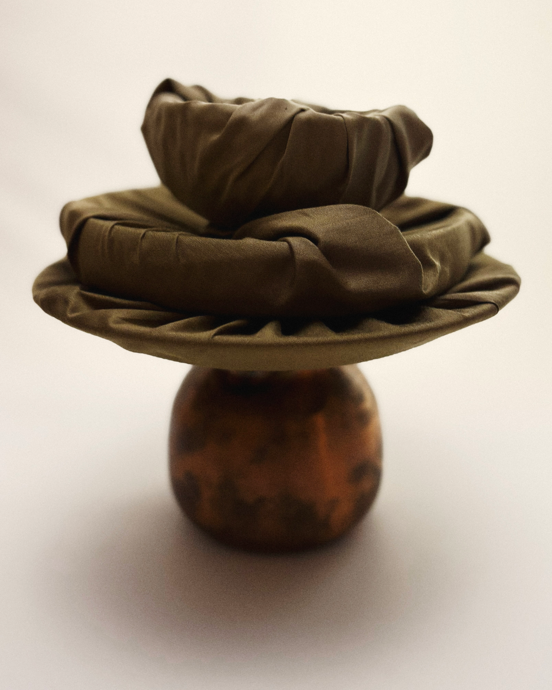 amaldhatu packing a copper vessel jug with a bunch of cloth covered objects