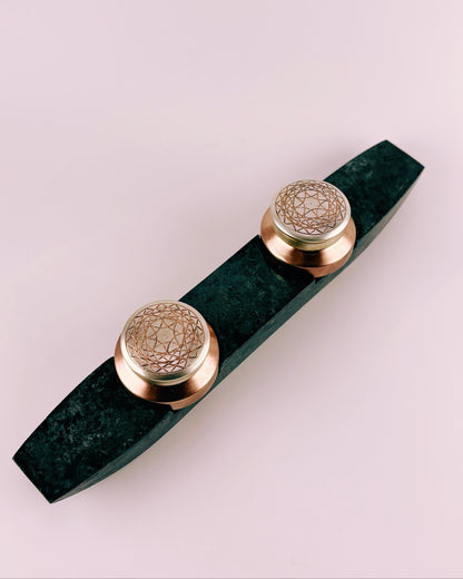 Decorative copper boxes on a green marble base